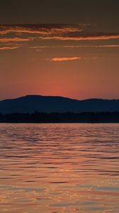 Preview wallpaper mountains, water, waves, glare, sunset