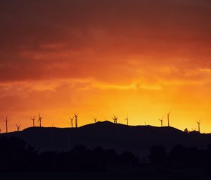 Preview wallpaper mountains, windmills, silhouette, sunset, sky