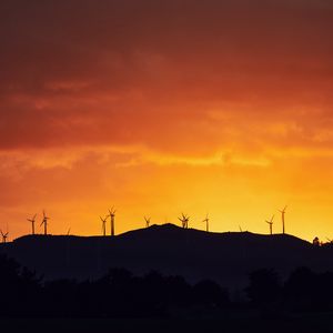 Preview wallpaper mountains, windmills, silhouette, sunset, sky