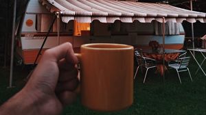 Preview wallpaper mug, hand, trailer, camping, travel