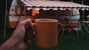 Preview wallpaper mug, hand, trailer, camping, travel