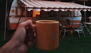 Preview wallpaper mug, hand, trailer, camping, travel