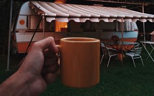 Preview wallpaper mug, hand, trailer, camping, travel