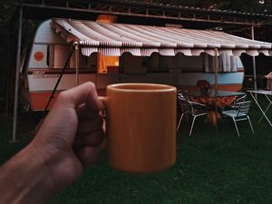 Preview wallpaper mug, hand, trailer, camping, travel