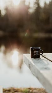 Preview wallpaper mug, pier, lake, sunlight, glare, blur