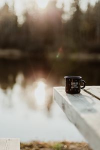 Preview wallpaper mug, pier, lake, sunlight, glare, blur