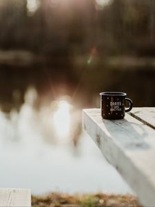 Preview wallpaper mug, pier, lake, sunlight, glare, blur