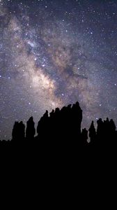 Preview wallpaper nebula, starry sky, rocks, stars, silhouette