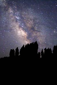 Preview wallpaper nebula, starry sky, rocks, stars, silhouette