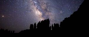 Preview wallpaper nebula, starry sky, rocks, stars, silhouette