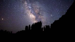 Preview wallpaper nebula, starry sky, rocks, stars, silhouette