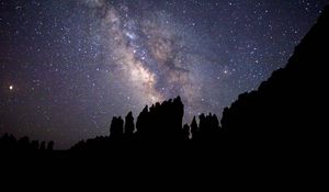 Preview wallpaper nebula, starry sky, rocks, stars, silhouette