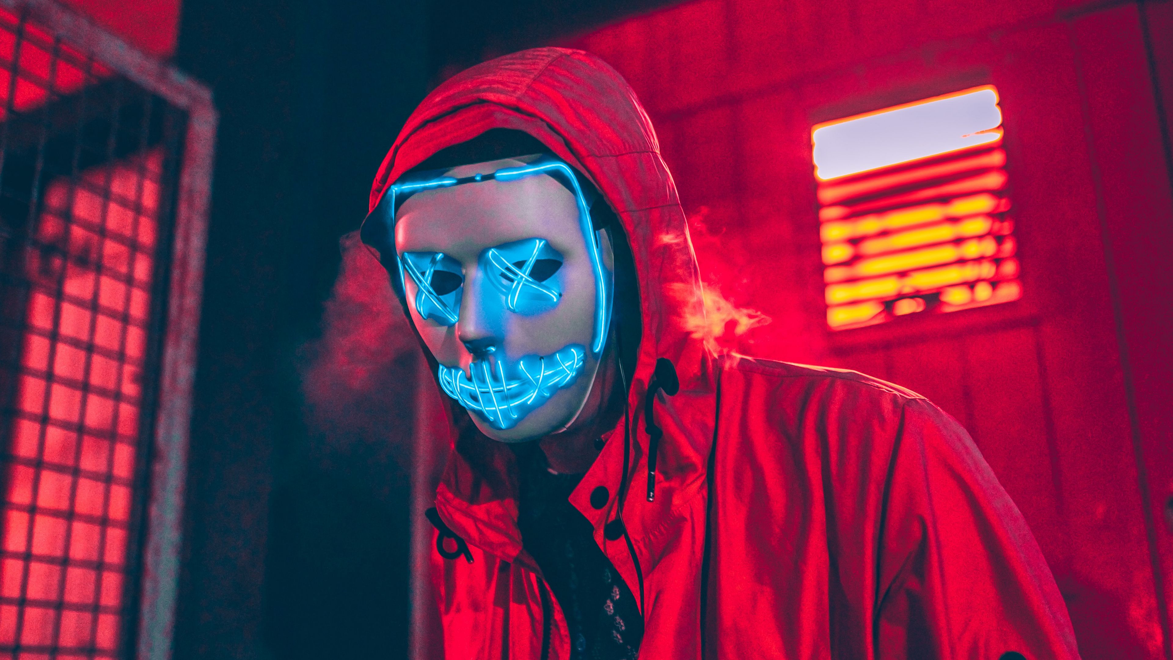 Premium AI Image | A neon mask with blue and yellow eyes holds a cigarette  in his mouth