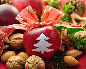 Preview wallpaper new year, holiday, table, apples, ribbon, bow, decoration, walnuts, pine needles, pine cones, cinnamon
