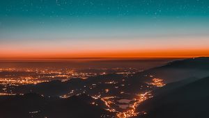 Preview wallpaper night city, aerial view, mountains, lights, starry sky