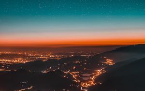 Preview wallpaper night city, aerial view, mountains, lights, starry sky
