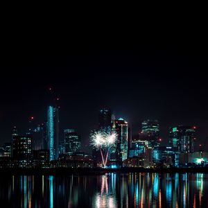 Preview wallpaper night city, buildings, fireworks, water, reflection