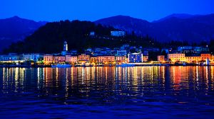 Preview wallpaper night city, buildings, hill, sea, night