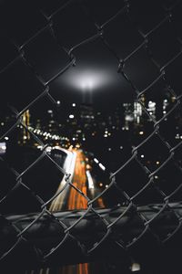 Preview wallpaper night city, fence, mesh, glare, blur