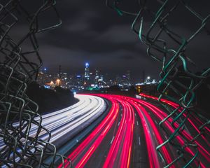 Preview wallpaper night city, fence, mesh, road, city lights, wire, movement