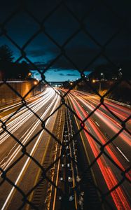 Preview wallpaper night city, fence, mesh, road, long exposure