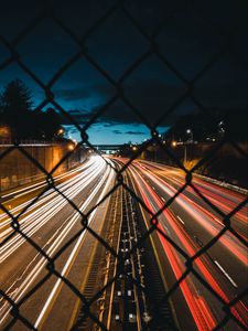 Preview wallpaper night city, fence, mesh, road, long exposure