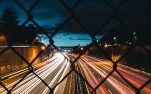 Preview wallpaper night city, fence, mesh, road, long exposure