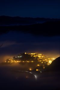 Preview wallpaper night, city, lights, mountains, fog, italy, aerial view