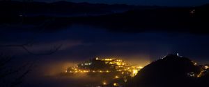 Preview wallpaper night, city, lights, mountains, fog, italy, aerial view