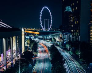 Preview wallpaper night city, road, buildings, ferris wheel, lights, long exposure