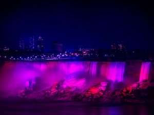 Preview wallpaper night city, waterfall, lights, stones, architecture, buildings