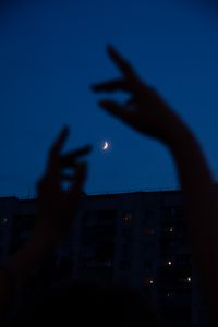 Preview wallpaper night, moon, dark, hands, building