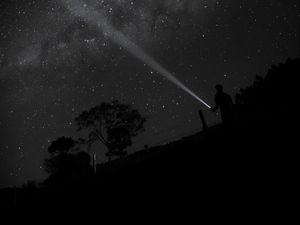 Preview wallpaper night, starry sky, man, flashlight, glow