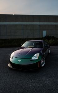 Preview wallpaper nissan, car, sports car, front view, headlights, building