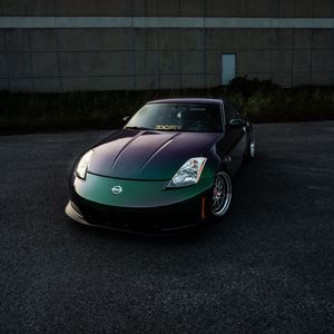 Preview wallpaper nissan, car, sports car, front view, headlights, building
