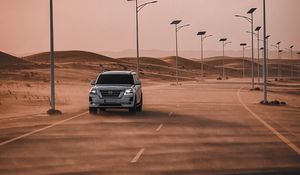Preview wallpaper nissan, suv, car, road, desert