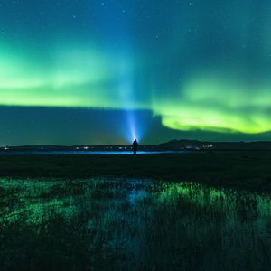 Preview wallpaper northern lights, man, night, glow, flashlight