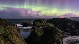 Preview wallpaper northern lights, rocks, bridge, sea, storm