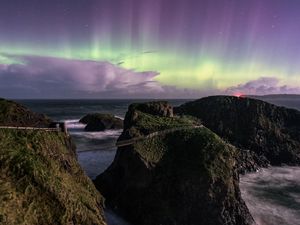 Preview wallpaper northern lights, rocks, bridge, sea, storm