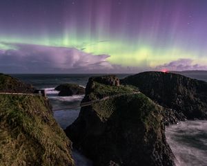 Preview wallpaper northern lights, rocks, bridge, sea, storm