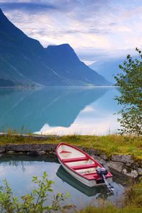 Preview wallpaper norway, boat, mountains, blue water, lake, coast, stones, grass