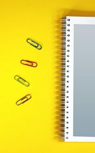 Preview wallpaper notebook, paper clips, surface, yellow