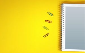 Preview wallpaper notebook, paper clips, surface, yellow
