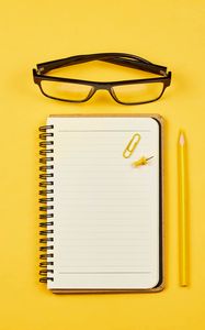 Preview wallpaper notepad, glasses, paper clip, pencil, yellow