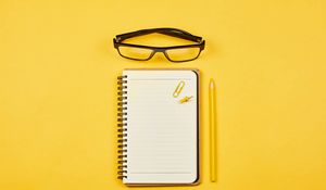 Preview wallpaper notepad, glasses, paper clip, pencil, yellow