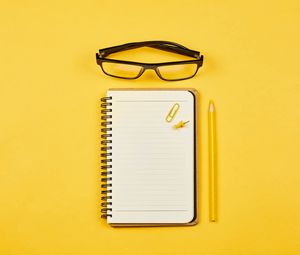 Preview wallpaper notepad, glasses, paper clip, pencil, yellow