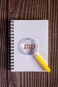 Preview wallpaper notepad, magnifying glass, 2023, wood, new year