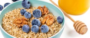 Preview wallpaper oatmeal, berries, nuts, bowl, breakfast