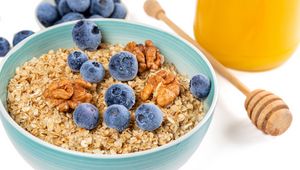 Preview wallpaper oatmeal, berries, nuts, bowl, breakfast