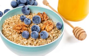 Preview wallpaper oatmeal, berries, nuts, bowl, breakfast